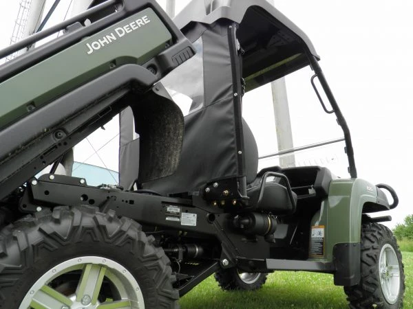 Low side angle of the 3 Star back panel edge strapped to the cab frame beside the John Deere Gator cargo bed
