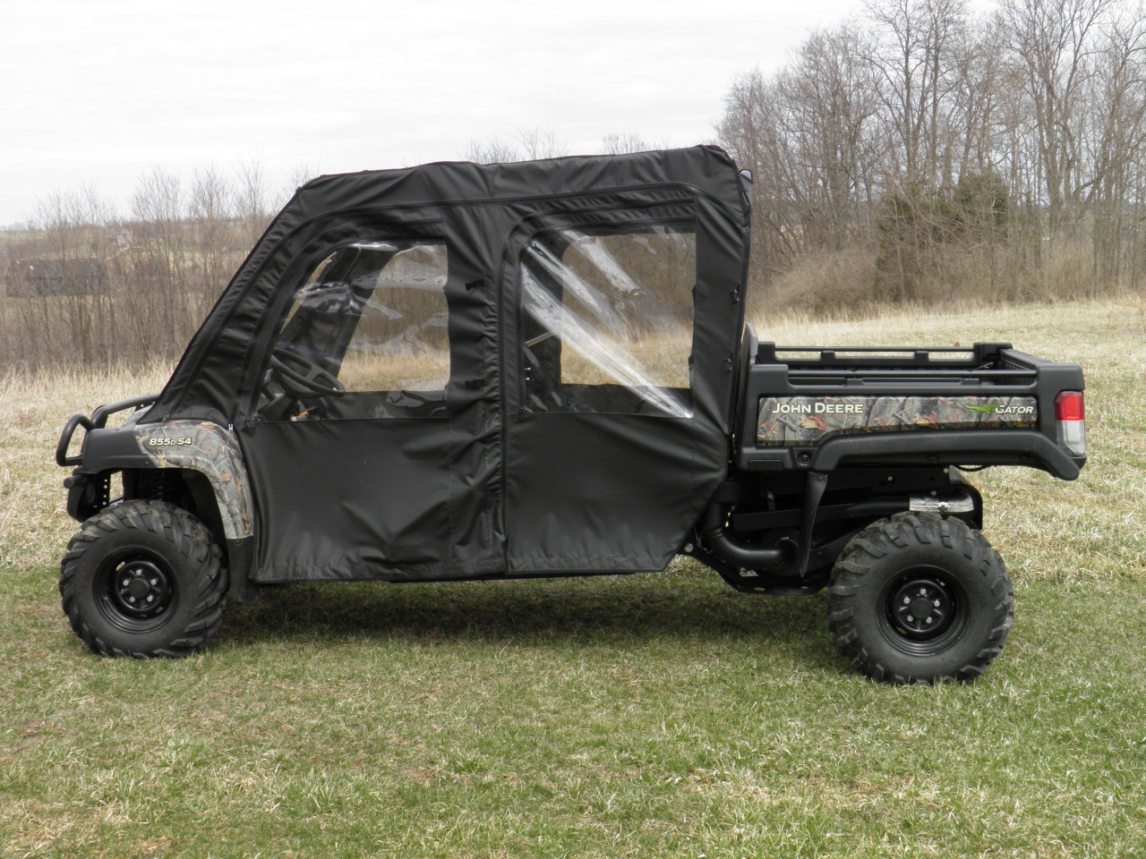 3 Star black soft doors kit with clear windows installed on a camo John Deere Gator XUV-4, side view on grass