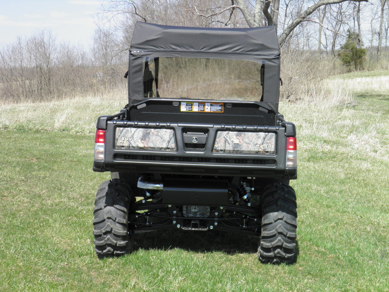 Straight rear view of a camo John Deere Gator with the 3 Star rear window panel and top above the tailgate