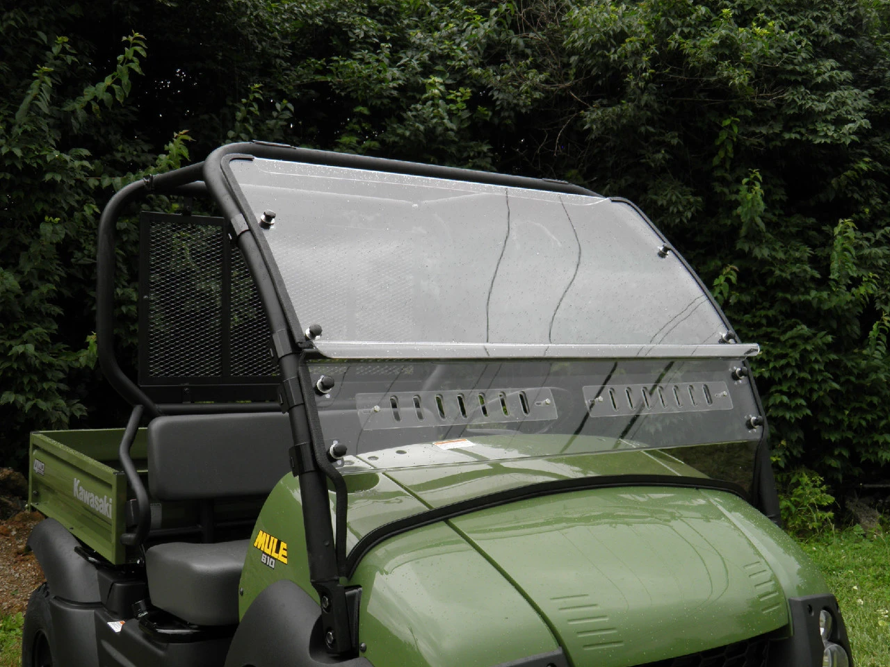 3 Star two-piece windshield with vent slots on a green Kawasaki Mule 600/610, front three-quarter close-up