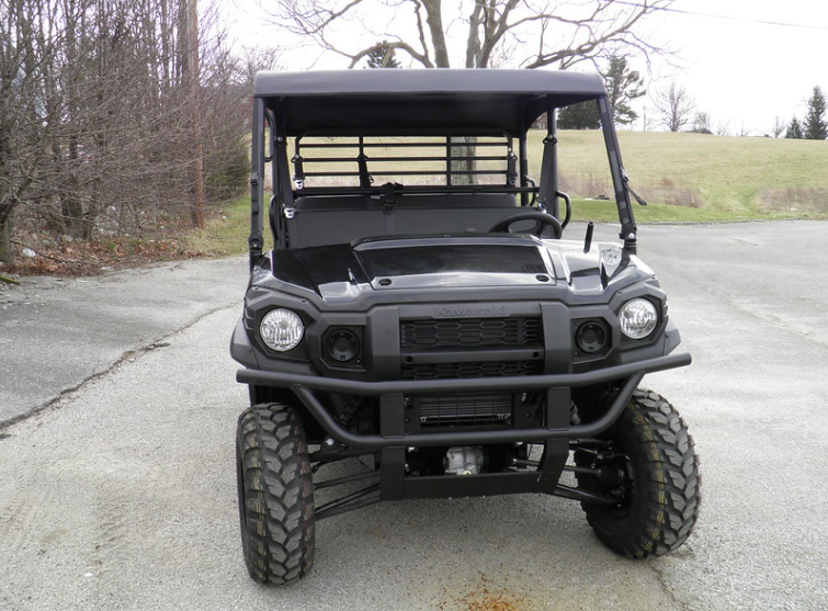 Straight front view of the black Kawasaki Mule with the 3 Star soft top and mesh headache rack behind the seats