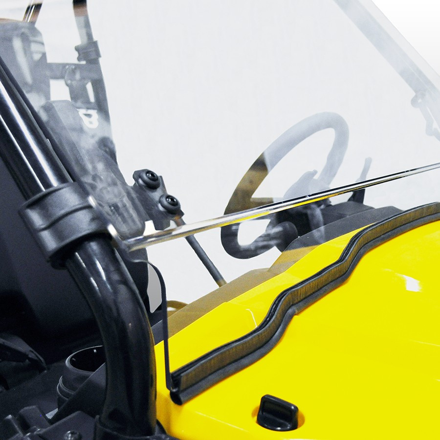 Close-up of the Kolpin Full Tilt windshield lower edge and A-pillar clamp above the yellow Honda Pioneer hood