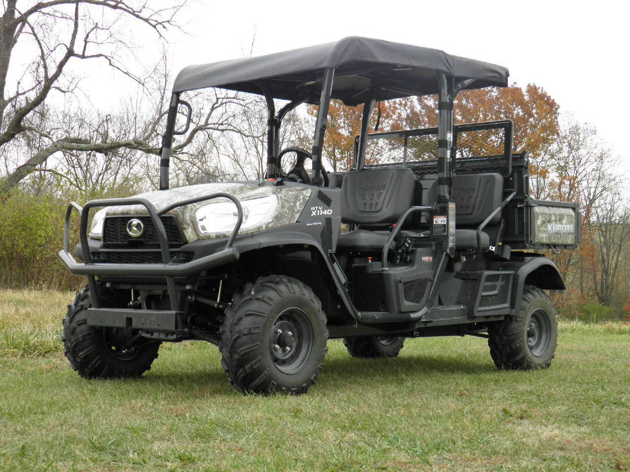 3 Star black soft top installed on a camo Kubota RTV X1140 four-seat crew cab, front three-quarter view in a field