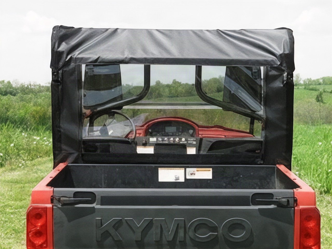 3 Star soft back panel with clear window behind the cab of a red Kymco, straight rear view over the cargo bed
