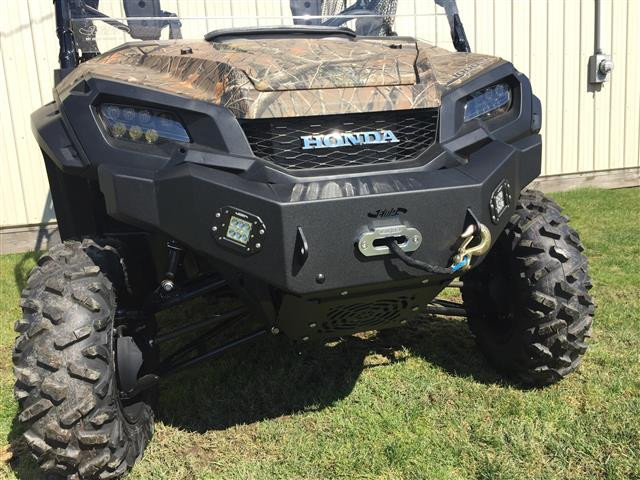 Straight-on front view of the camo Honda Pioneer 1000 with the Extreme Metal Products winch bumper and LED lights