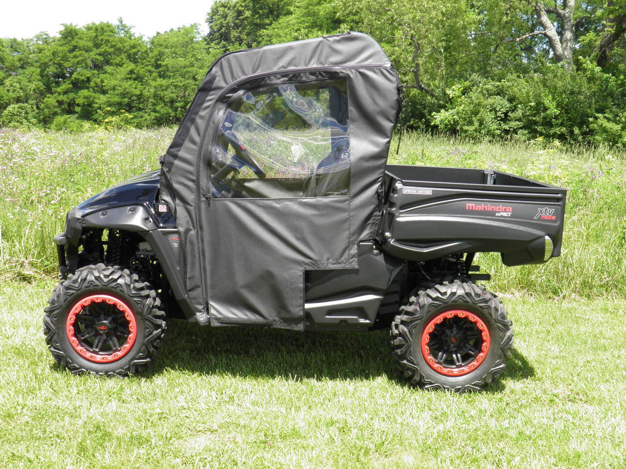 3 Star soft doors kit installed on a black Intimidator Classic with red-lip wheels, side view in a field