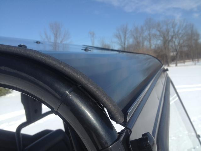 Close-up of the Extreme Metal Products aluminum top edge and rubber trim along the Honda Pioneer 700 cage