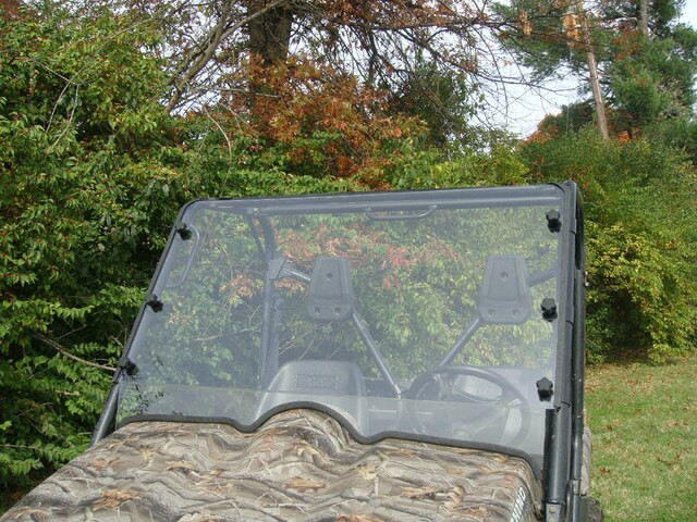 3 Star clear two-piece windshield with black clamps on a camo Yamaha Rhino, front view outdoors