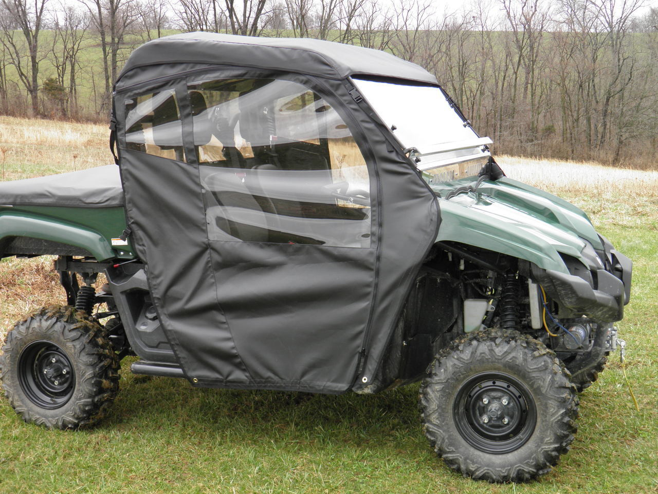 Front three-quarter view of a green Yamaha Viking with the 3 Star soft doors and rear window installed