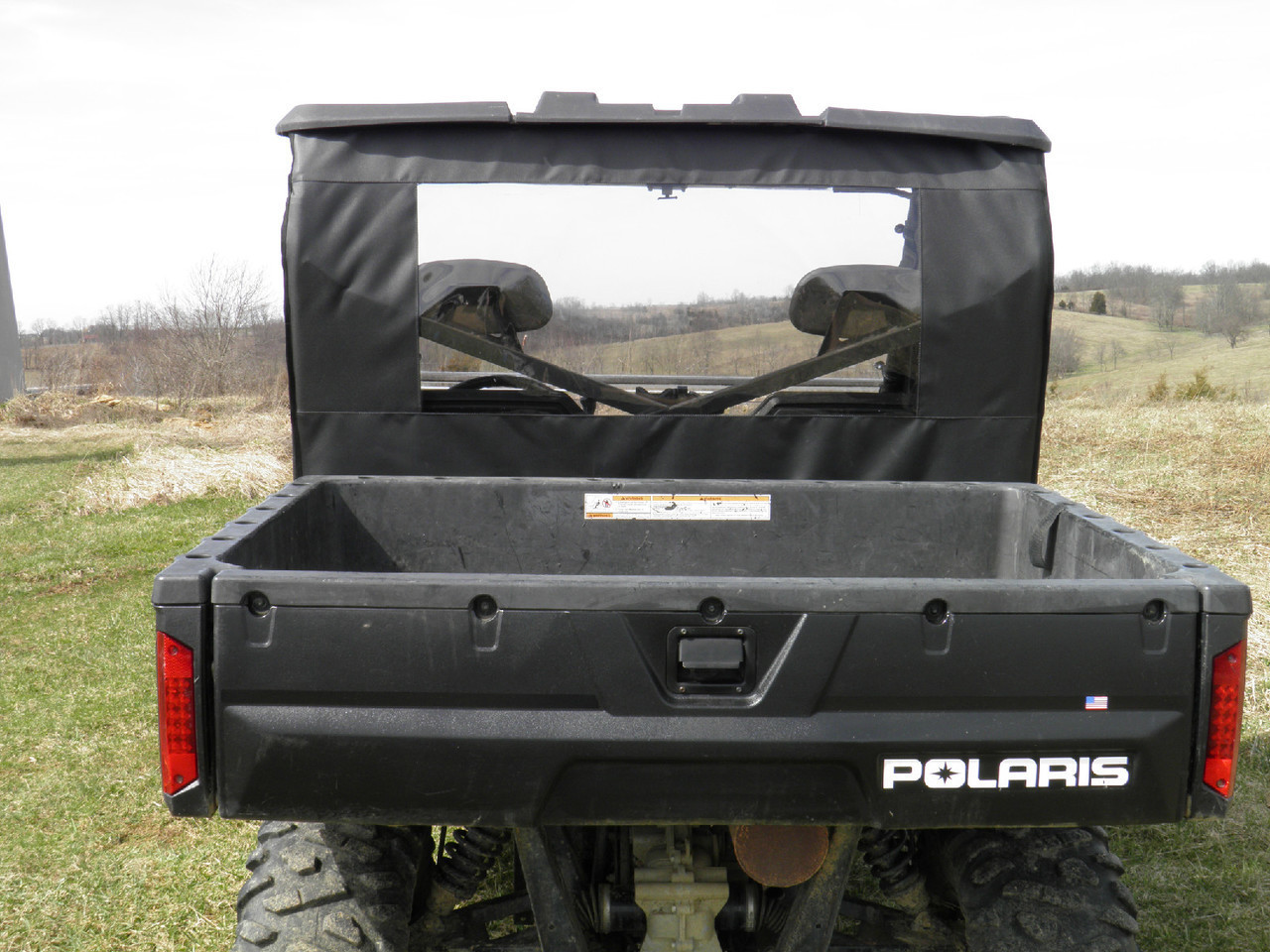 Rear view of the 3 Star rear window panel seen over the tailgate of a side-by-side cargo bed