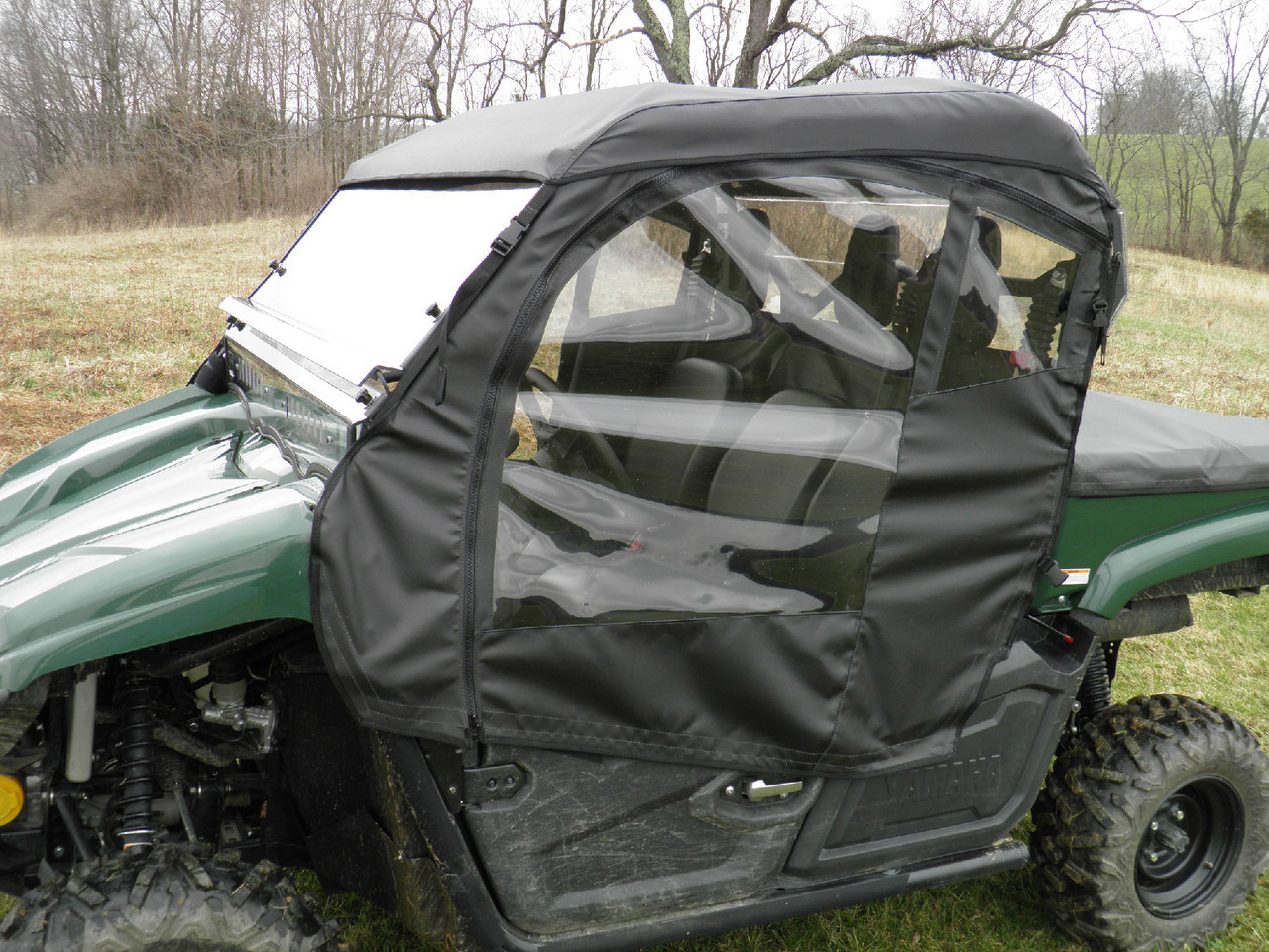Side view of the 3 Star enclosure soft door with clear window, top and windshield on the green Yamaha Viking