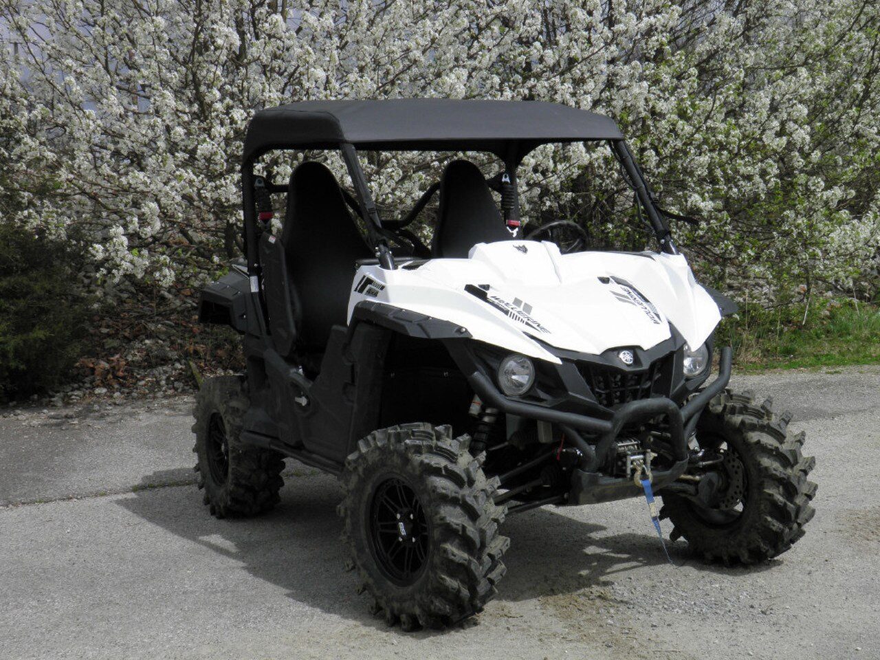 Front three-quarter view of a white Yamaha Wolverine with the 3 Star soft top installed