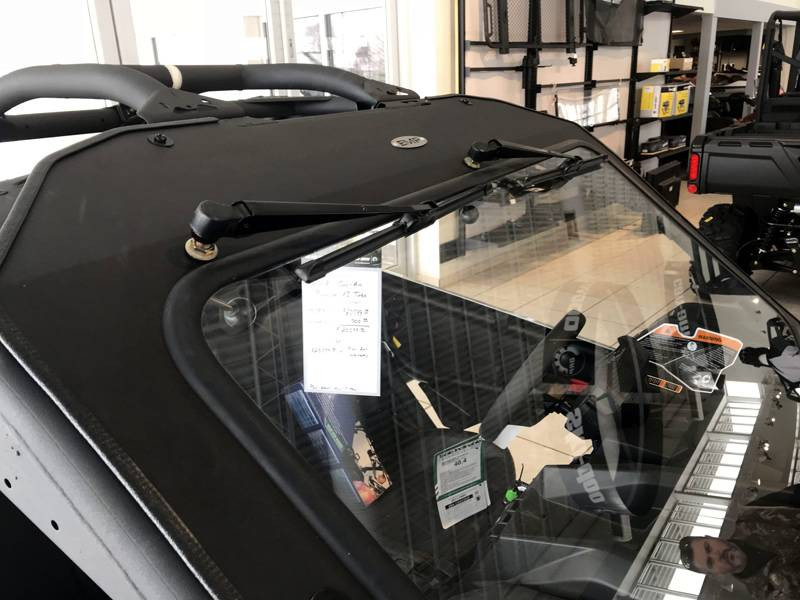 Front view of the Extreme Metal Products glass windshield and wiper arm on the Can-Am Maverick X3 in a showroom