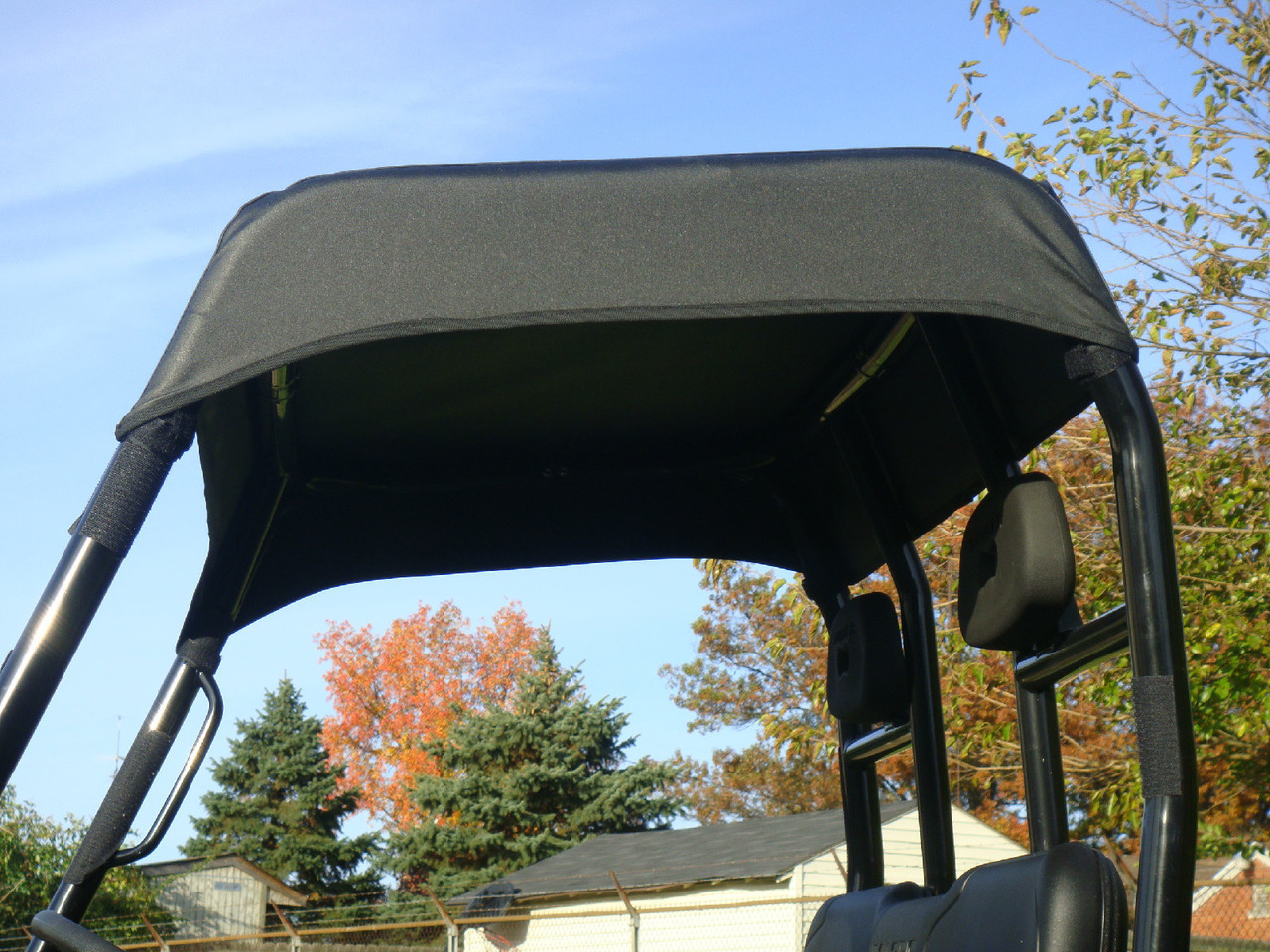 3 Star black soft top installed over the roll cage of a Polaris Ranger, close underside view against blue sky