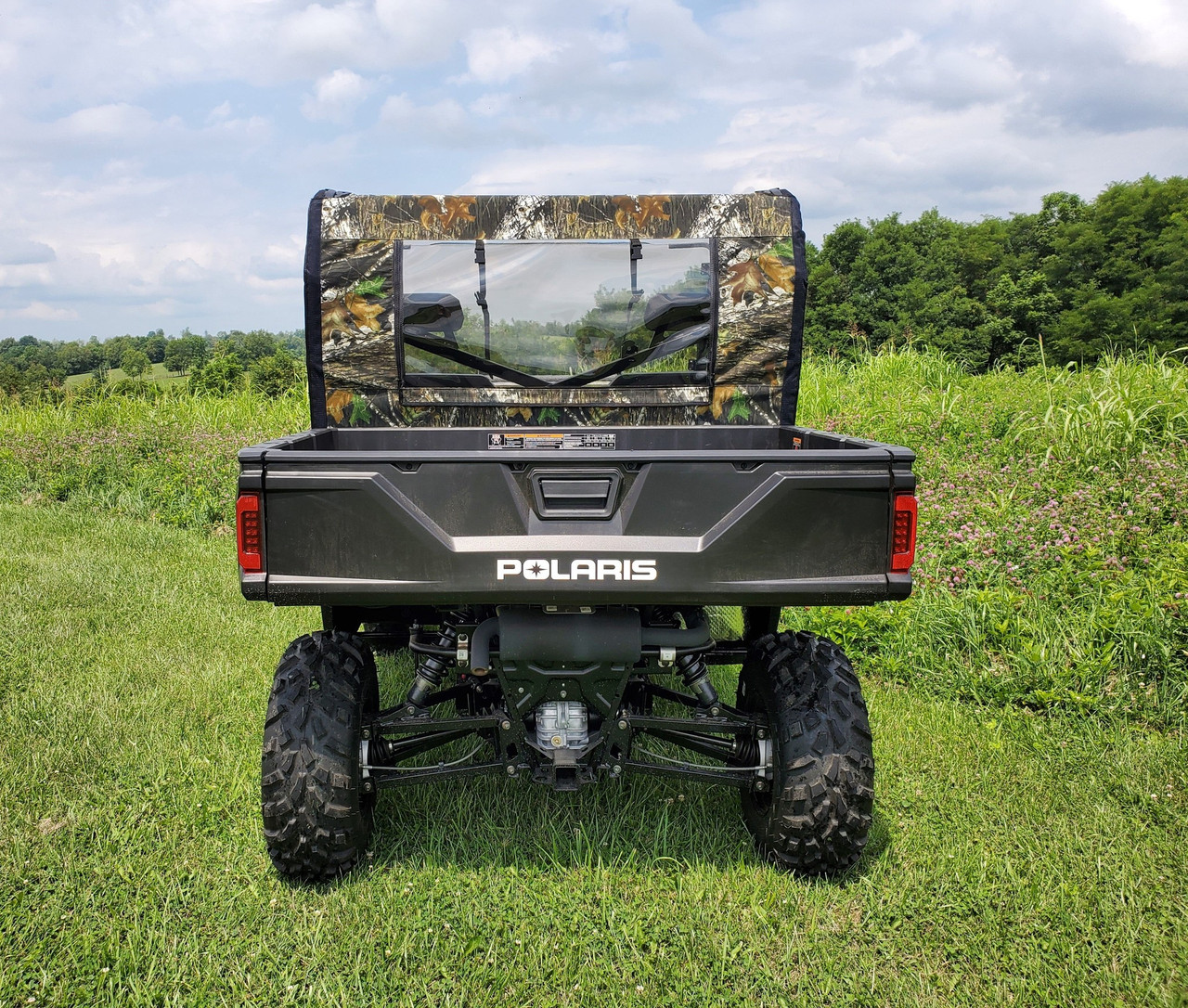 3 Star camo soft back panel with clear window on a Polaris Ranger, straight rear view on grass
