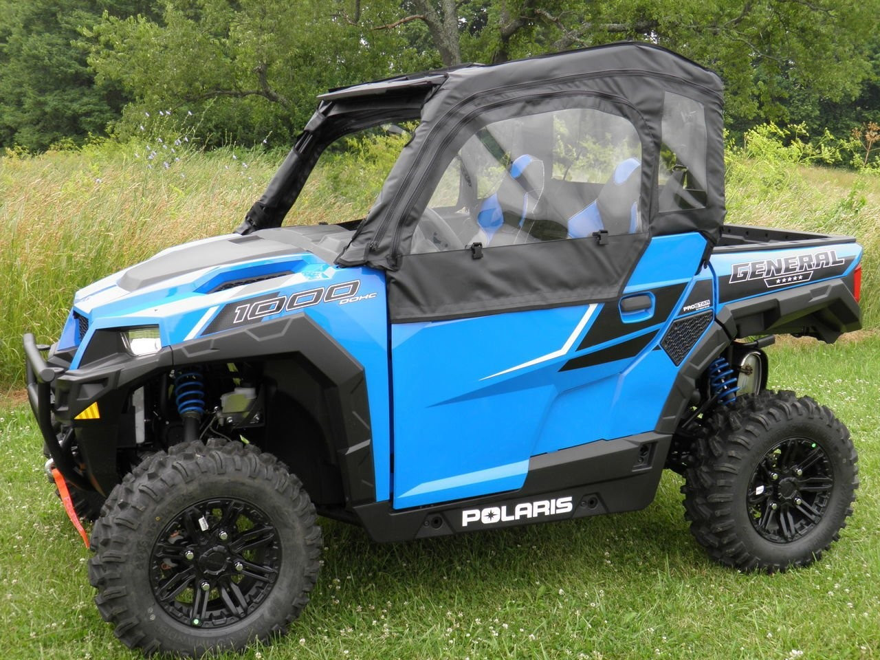 3 Star soft doors on a blue Polaris General, black doors with clear windows, front 3/4 view on grass