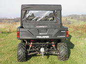 Small rear view of a Polaris Ranger with the 3 Star rear window panel installed behind the cab