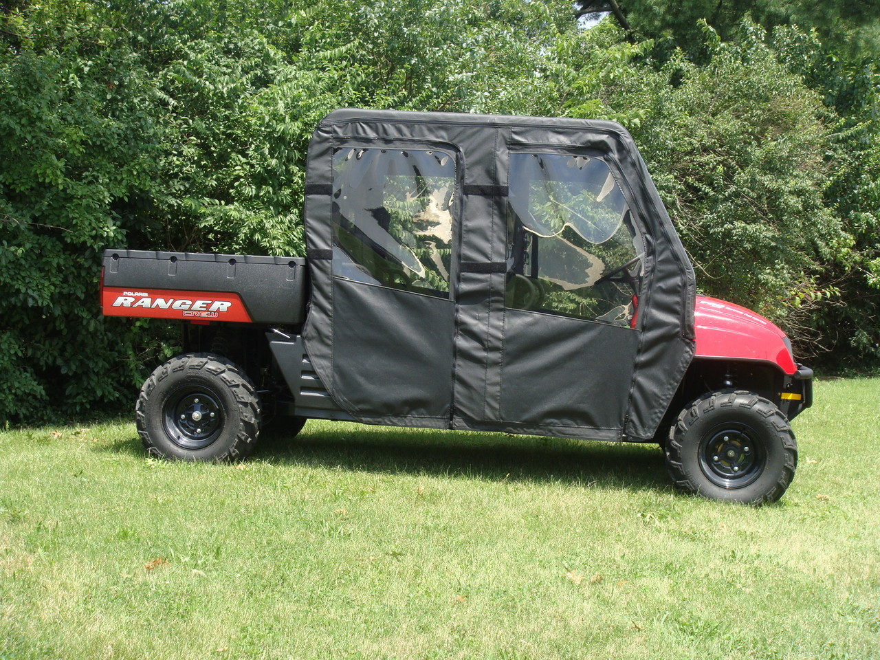 3 Star black soft doors with clear windows on a red Polaris Ranger 700 Crew, side view of the four-door enclosure