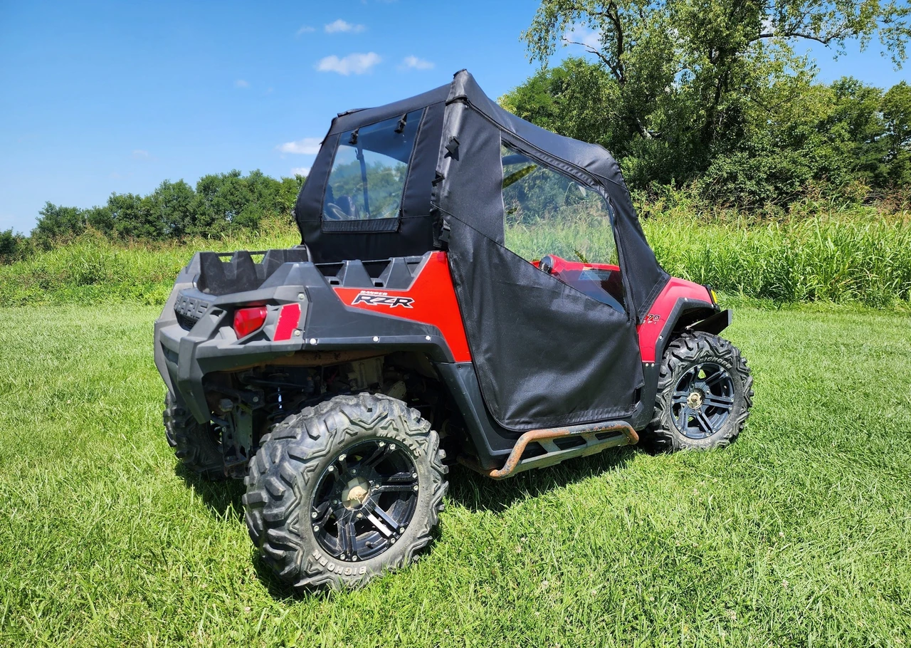 3 Star soft doors and rear window combo installed on a red Polaris RZR, side view in a grassy field