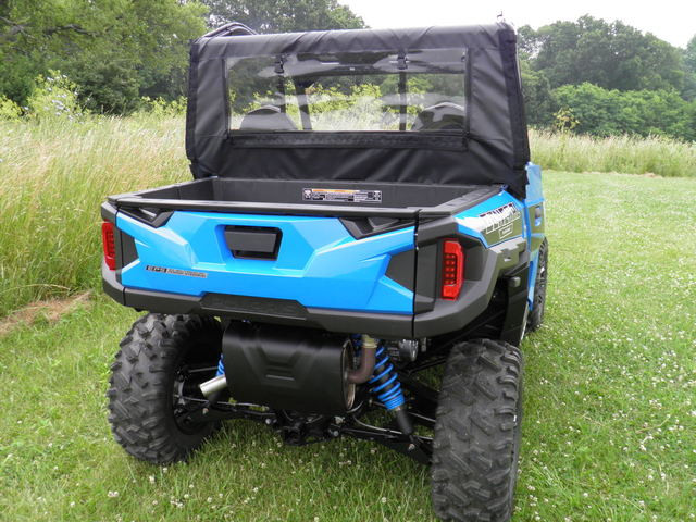 Rear three-quarter view of the 3 Star full cab enclosure with rear window on a blue Polaris side-by-side