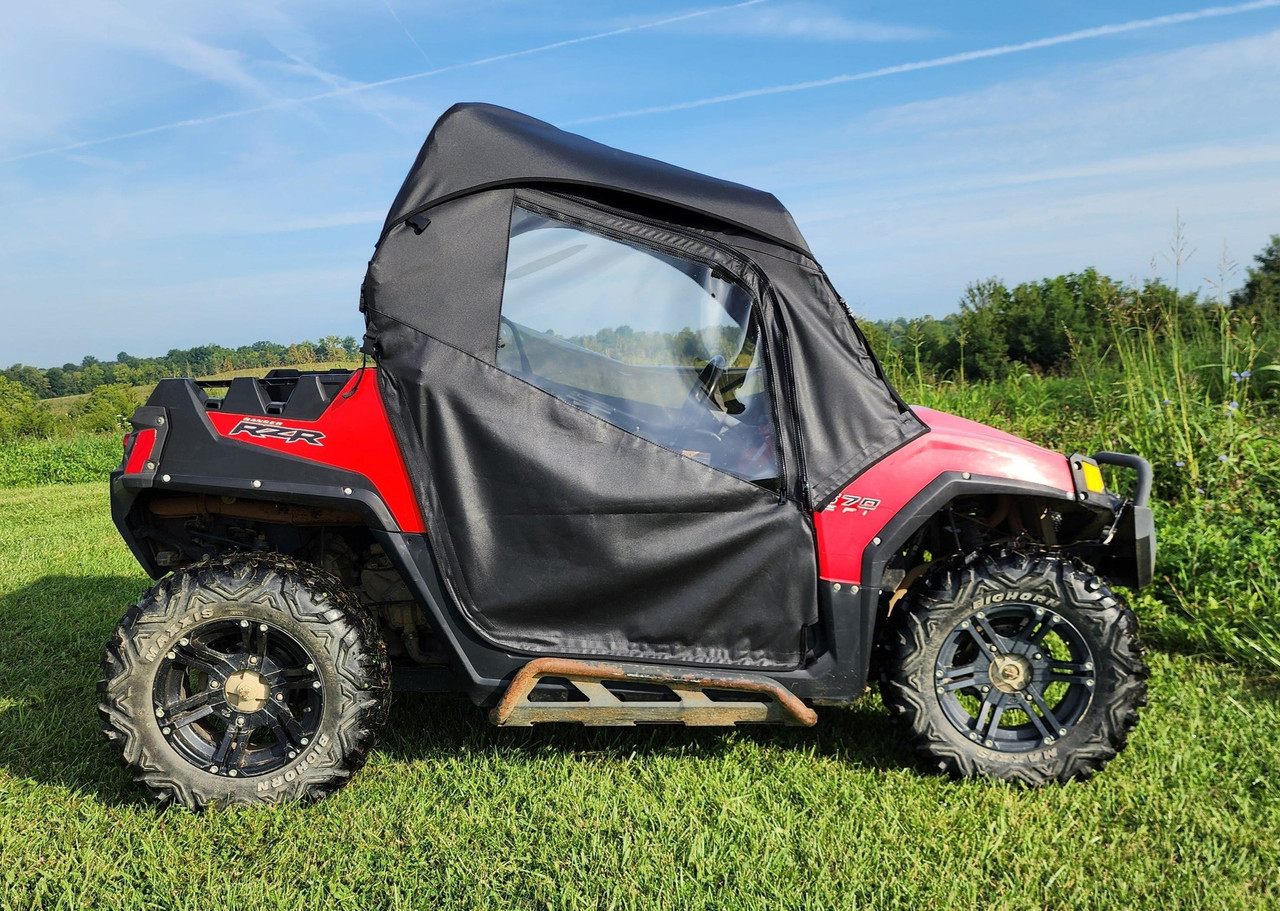 3 Star full cab enclosure for hard windshield installed on a red Polaris RZR, side view in a field