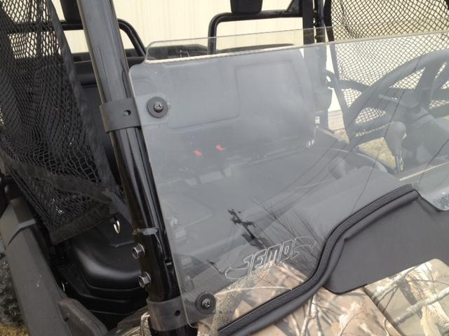 Angled close-up of the Extreme Metal Products half windshield edge and cage clamp on the Honda Pioneer 700 driver side