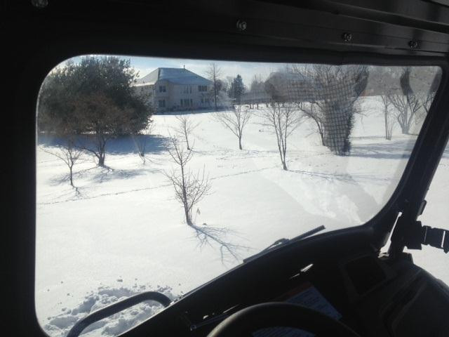 View through the Extreme Metal Products glass windshield from the Honda Pioneer 700 driver seat toward a snowy yard