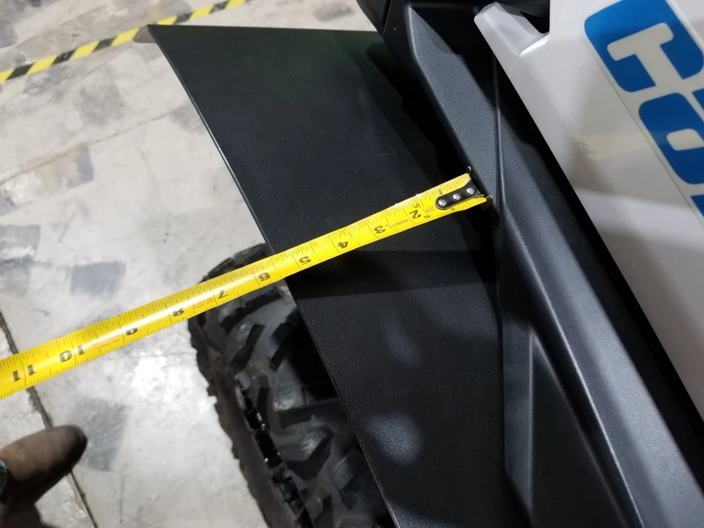 Tape measure across the Trail Armor fender extension on the Can-Am Maverick Sport showing its width over the tire