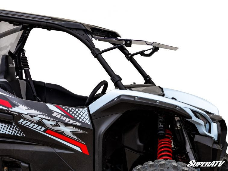SuperATV flip windshield in the open position on a white Kawasaki Teryx KRX 1000, driver side close view