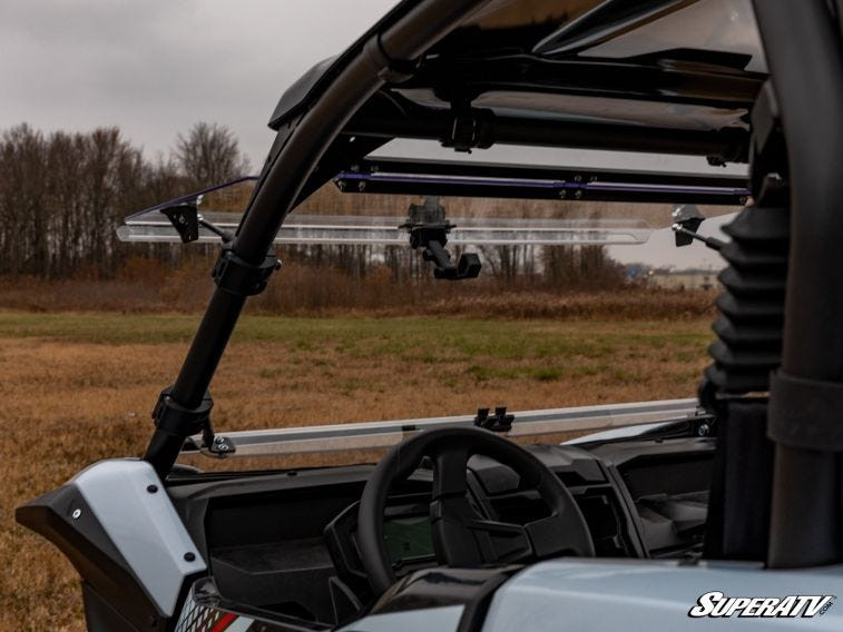 View from inside the Kawasaki Teryx KRX 1000 cab with the SuperATV windshield flipped up above the dash