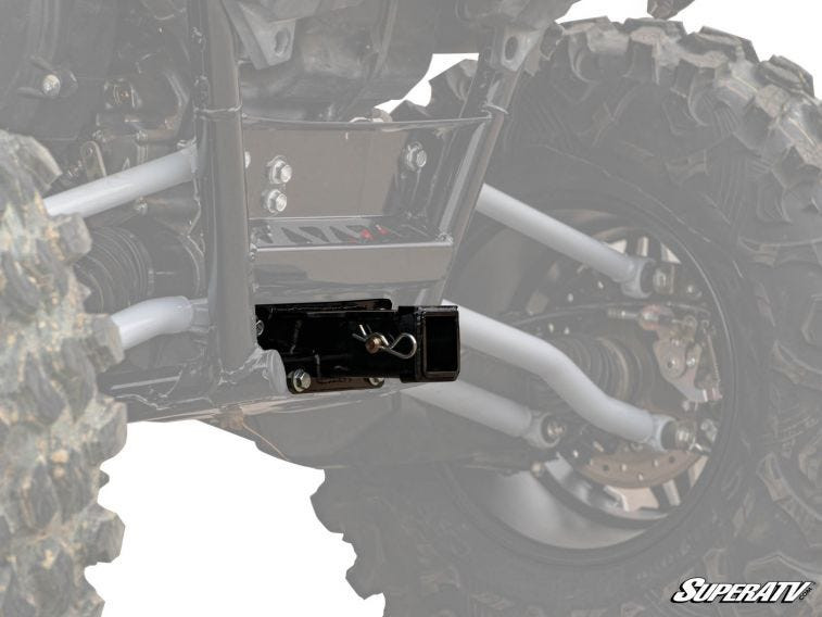 SuperATV rear receiver hitch installed under the rear of a Kawasaki Teryx KRX, close-up between the tires