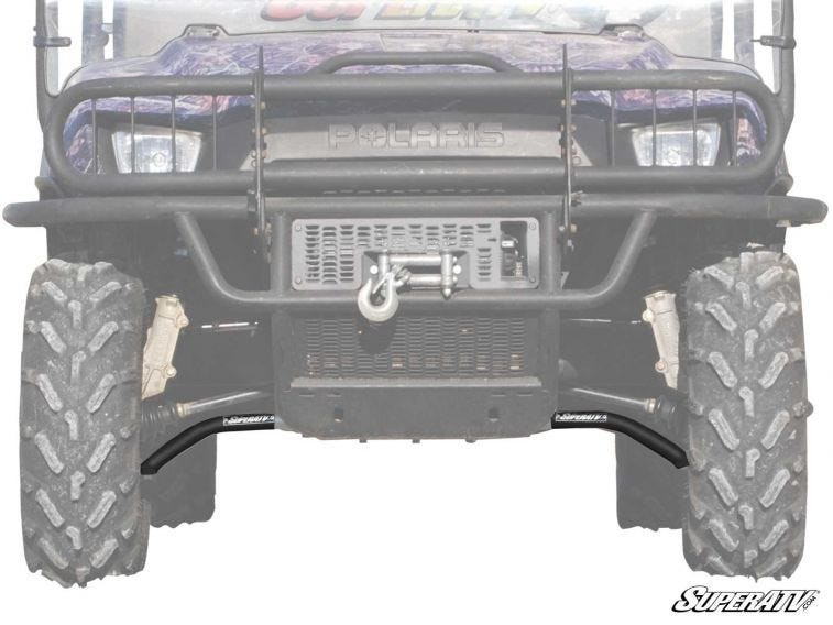 SuperATV high clearance A-arms installed under the front bumper of a faded-out side-by-side, front view