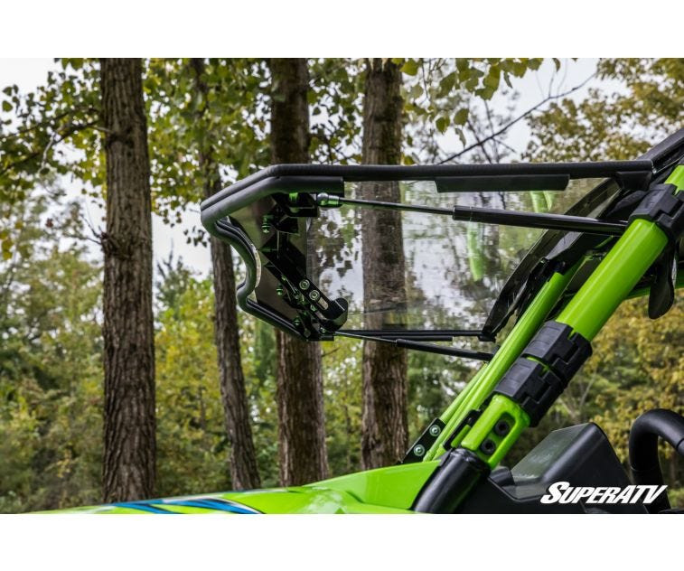 SuperATV flip windshield tilted open on the green cage of a Textron Wildcat XX, side close-up