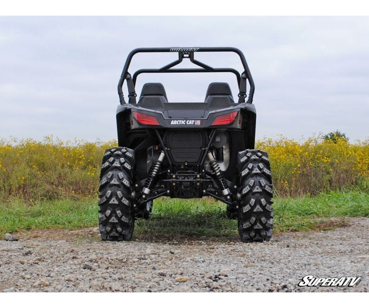 Rear view of a black Arctic Cat Wildcat Trail raised on the SuperATV 2-3 inch lift kit, showing ground clearance