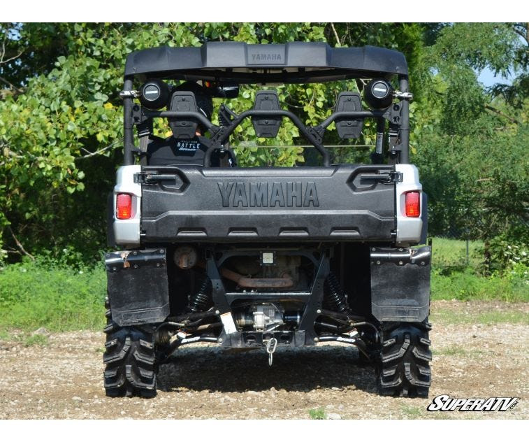 Rear view of a silver Yamaha Viking with the SuperATV 2-inch lift kit and mud tires on a gravel trail