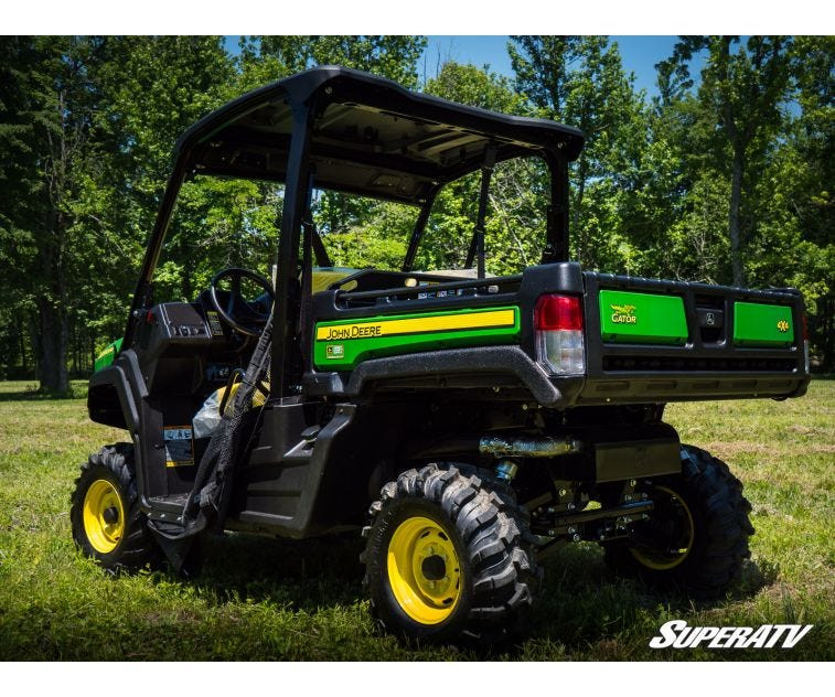 Rear three-quarter view of a John Deere Gator XUV 835 lifted with the SuperATV 2 inch kit and mud tires