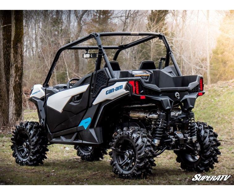 Rear three-quarter view of a white and black Can-Am Maverick Trail on the SuperATV 3-inch lift with mud tires