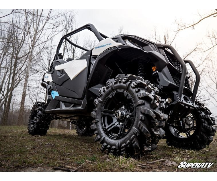 Low angle rear corner close-up of the lifted Can-Am Maverick Trail showing the mud tire and SuperATV lift