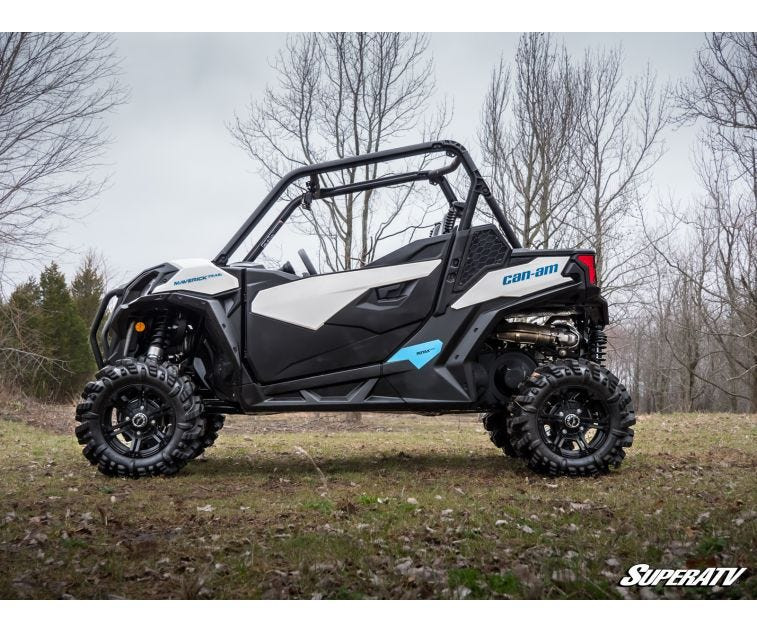 Side profile of the Can-Am Maverick Trail raised on the SuperATV 3-inch lift kit in the woods
