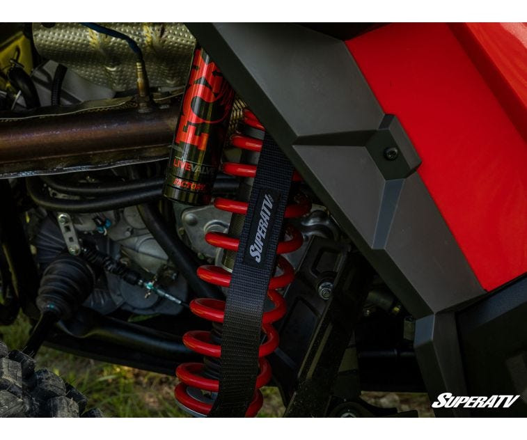 Close-up of the rear shock and SuperATV limit strap from the 3-inch lift kit on a Polaris RZR XP Turbo S