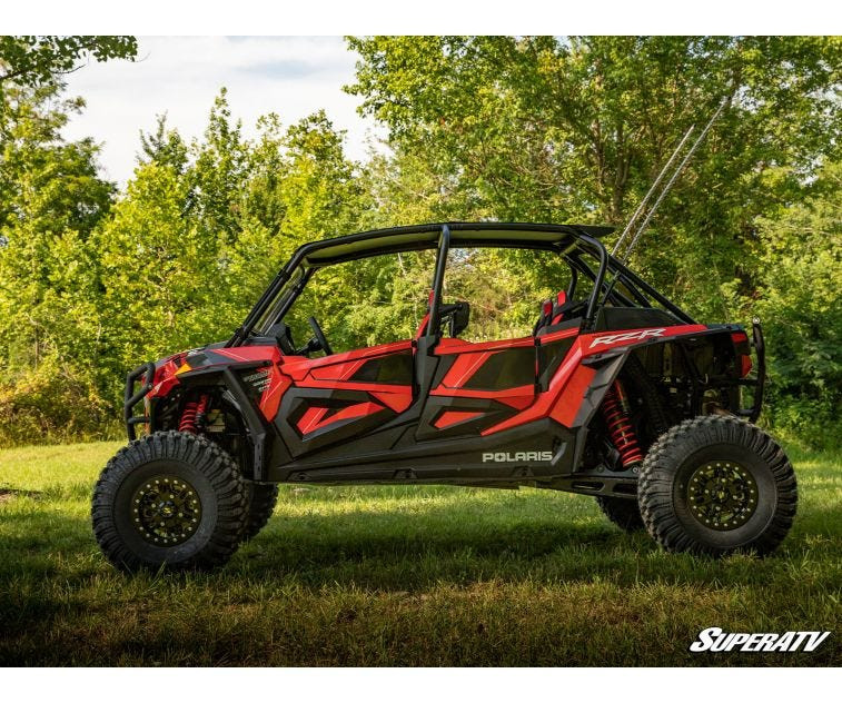Side profile of a red four-seat Polaris RZR XP Turbo S sitting higher on the SuperATV 3-inch lift kit