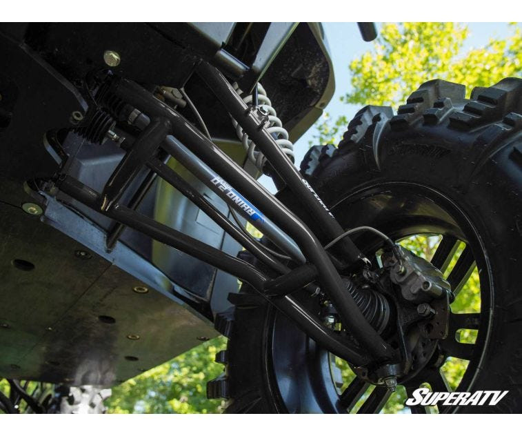 Underside close-up of the SuperATV lift kit rear arm and axle installed on the Polaris Ranger XP 1000 with mud tire