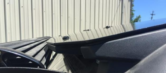 Underside of the Extreme Metal Products aluminum top at the rear edge showing the mounting brackets on the General 1000 cage