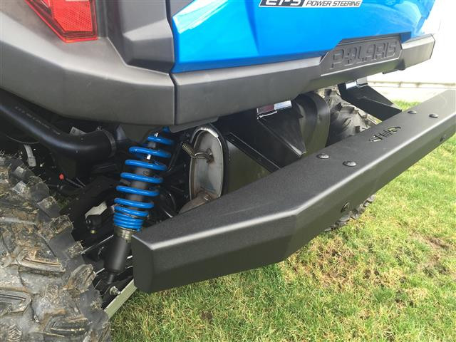 Low close-up of the Extreme Metal Products rear bumper below the blue Polaris General with exhaust and blue shock