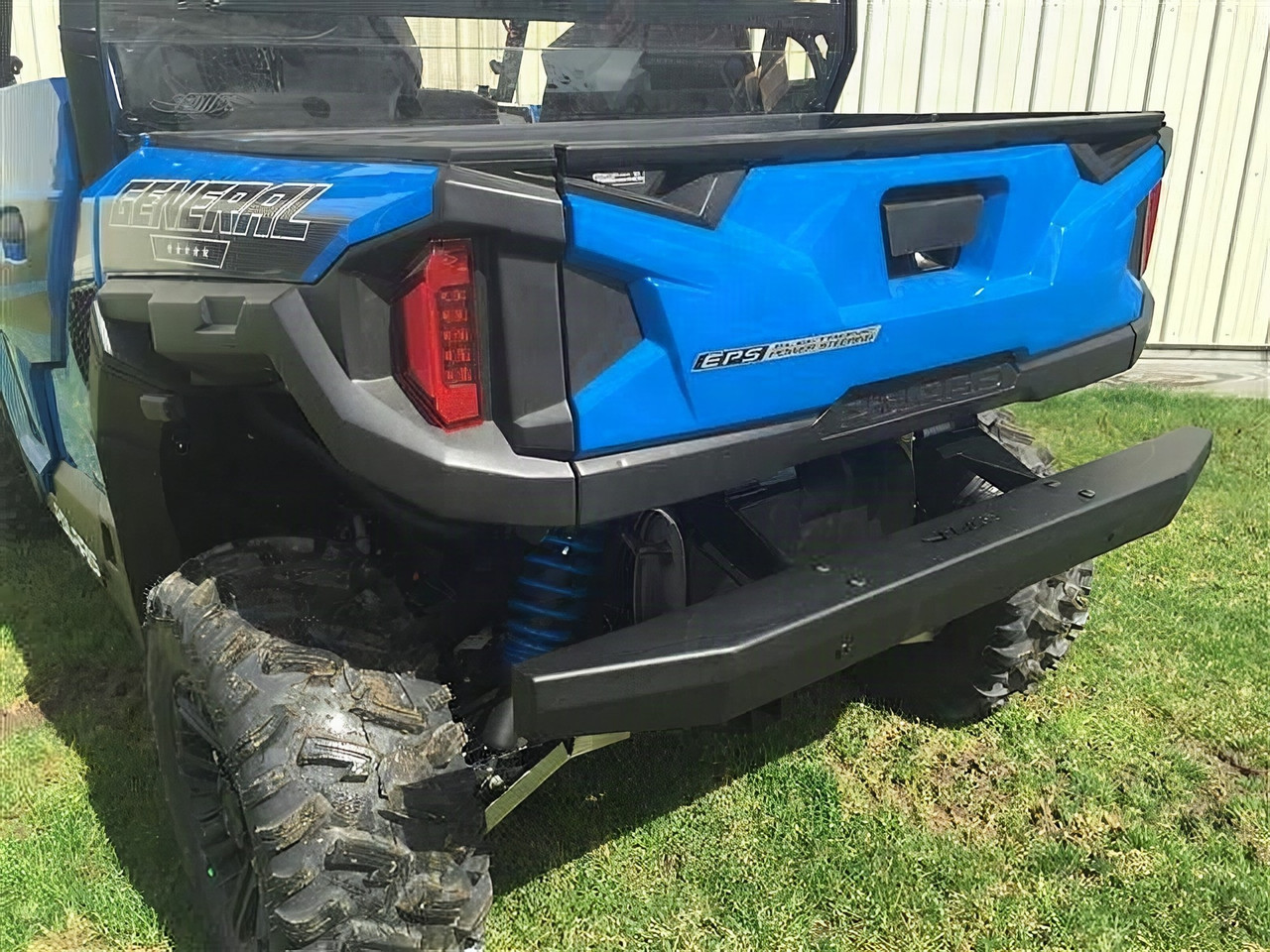 Extreme Metal Products black tube rear bumper installed under the tailgate of a blue Polaris General 1000, rear angle
