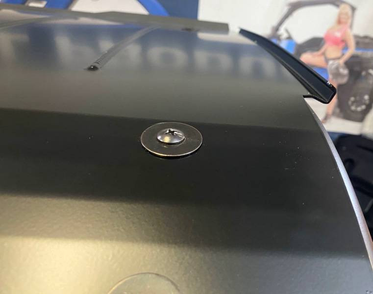 Close-up of a mounting bolt and the rear spoiler lip on the Extreme Metal Products RZR Pro XP roof