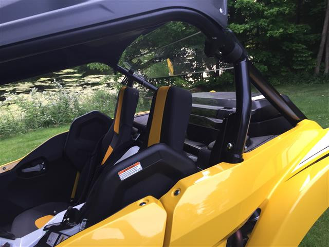 Passenger side view of the yellow Yamaha YXZ with the Extreme Metal Products rear window behind the seats, lawn behind