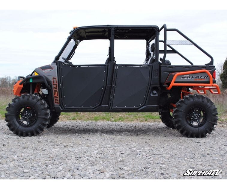 Side profile of a tan Polaris Ranger XP1000 fitted with four black SuperATV aluminum doors and mud tires
