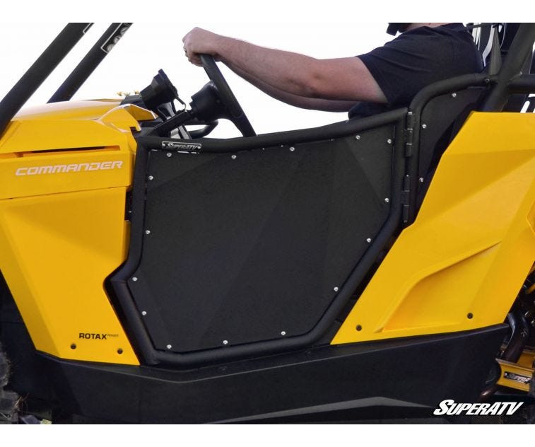 Side close-up of the SuperATV aluminum door on the Can-Am Commander showing the riveted panel and tube frame