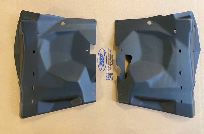 Extreme Metal Products firewall liners for Can-Am Maverick X3, pair of black textured plastic panels laid on a table